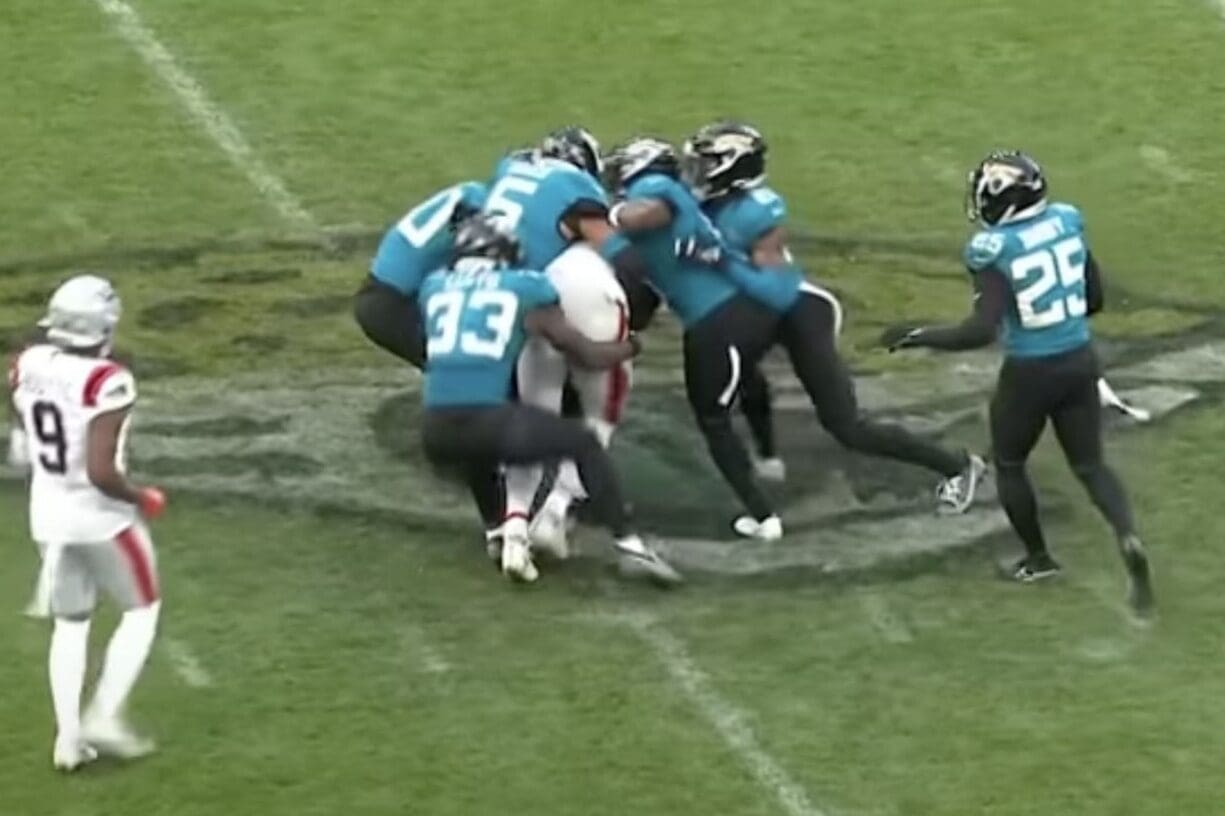 New England Patriots tight end Hunter Henry gets tackled by a group of Jacksonville Jaguars players in their Week 7 game.